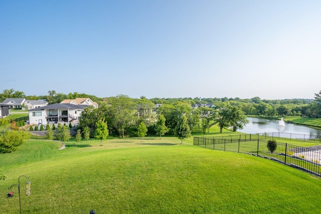 view of yard with fence and a water view