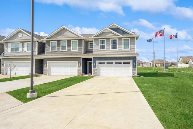 view of front facade with a garage, a front lawn, concrete driveway, and stone siding