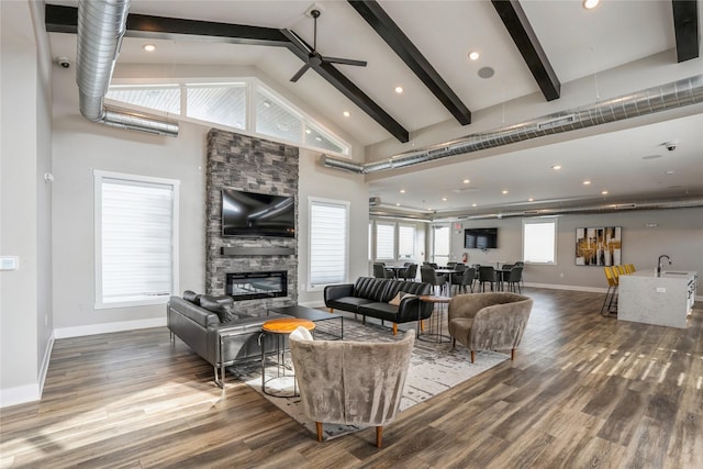 living room with baseboards, high vaulted ceiling, beam ceiling, and a fireplace