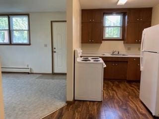 4713 Ontario St, Ames, IA 50014 - kitchen with white appliances, a sink, baseboard heating, light countertops, and dark wood-type flooring