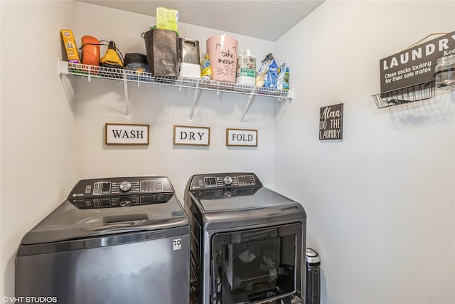 clothes washing area featuring independent washer and dryer and laundry area