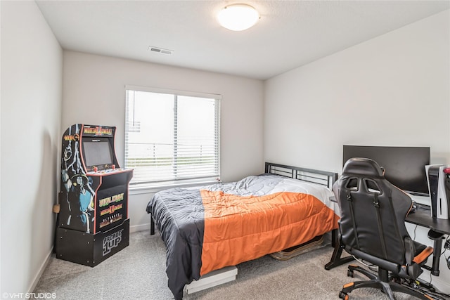 carpeted bedroom featuring baseboards and visible vents