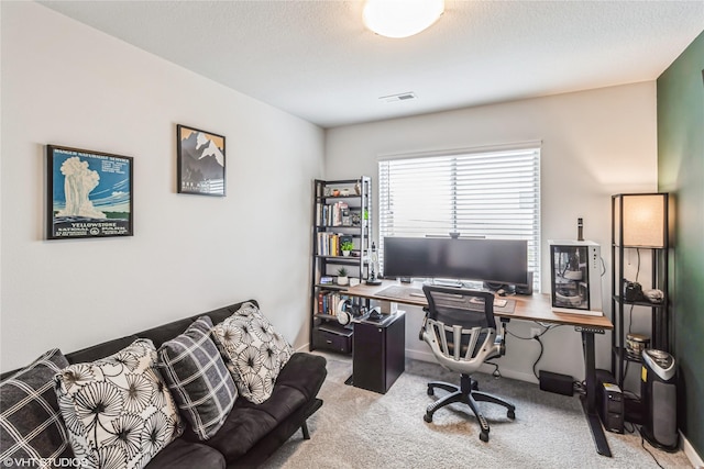 office area with visible vents and carpet flooring