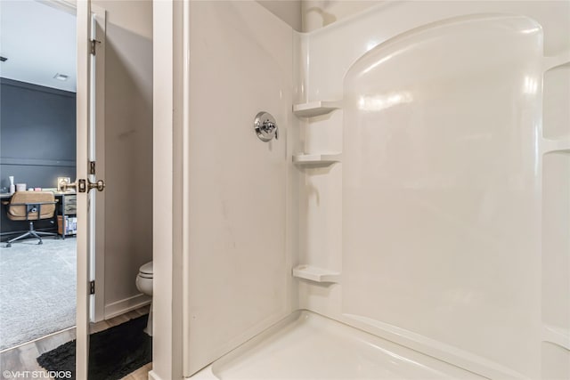 full bath with a walk in shower, wood finished floors, and toilet