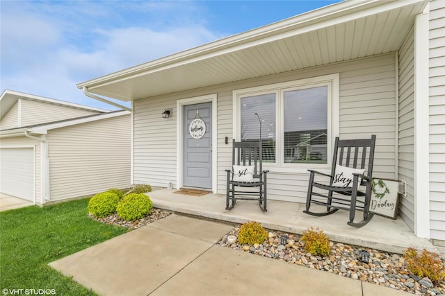 entrance to property with a porch and a garage