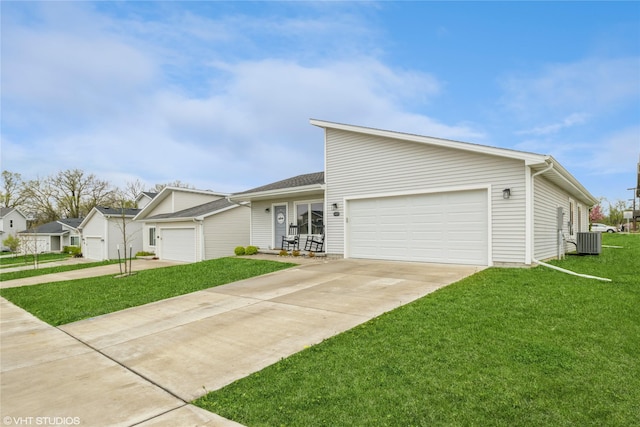 view of front of house with a front yard, driveway, a garage, and central AC unit