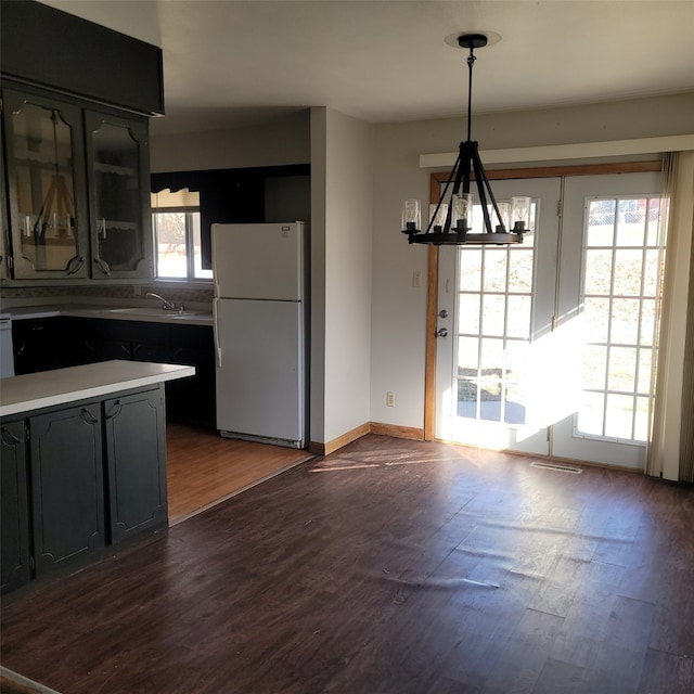 126 E Maxwelton Dr, Des Moines, IA 50315 - kitchen featuring dark wood-style floors, a sink, a notable chandelier, light countertops, and freestanding refrigerator