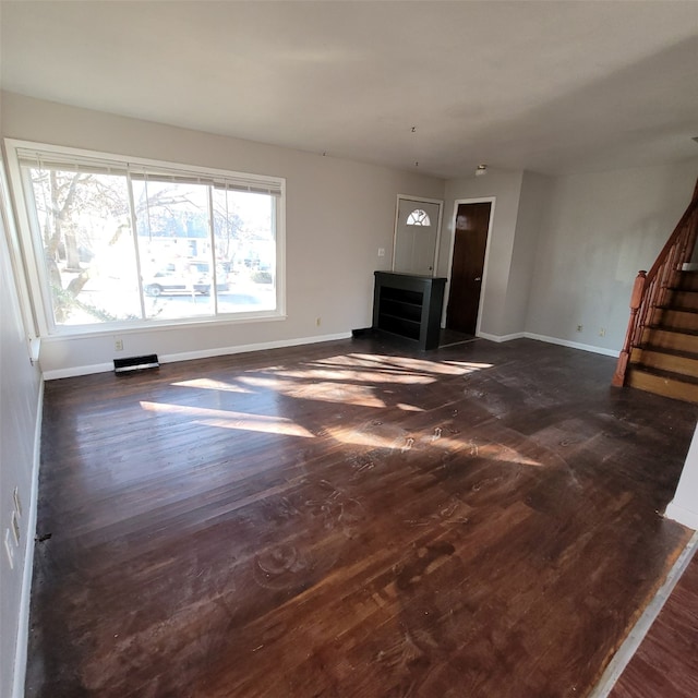 126 E Maxwelton Dr, Des Moines, IA 50315 - unfurnished living room featuring stairway, dark wood-type flooring, and baseboards