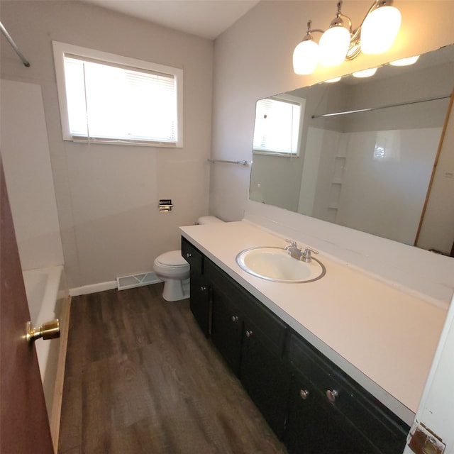126 E Maxwelton Dr, Des Moines, IA 50315 - full bathroom with vanity, toilet, visible vents, wood finished floors, and  shower combination
