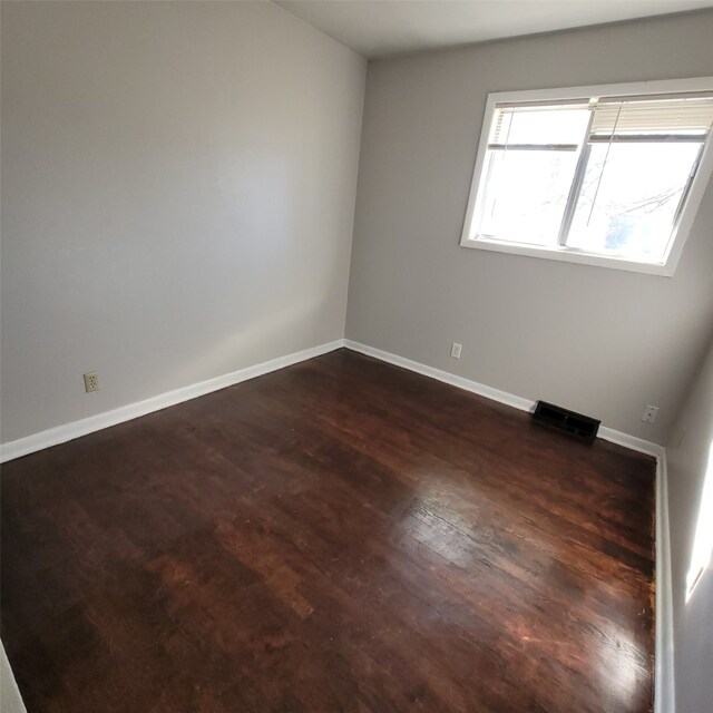 126 E Maxwelton Dr, Des Moines, IA 50315 - empty room with dark wood-type flooring, visible vents, and baseboards