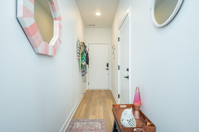hall with recessed lighting, baseboards, visible vents, and light wood-style floors