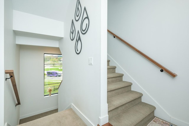 staircase with carpet floors and baseboards