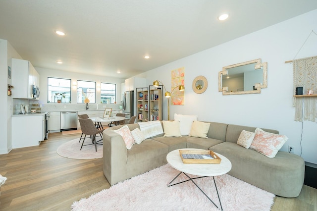 living area with recessed lighting and light wood-style flooring