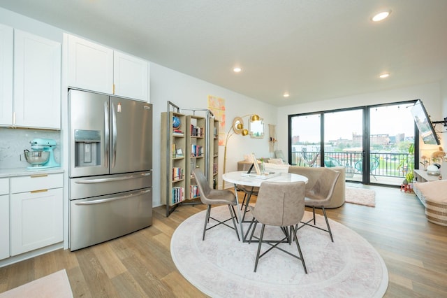 dining space featuring light wood-style floors and recessed lighting