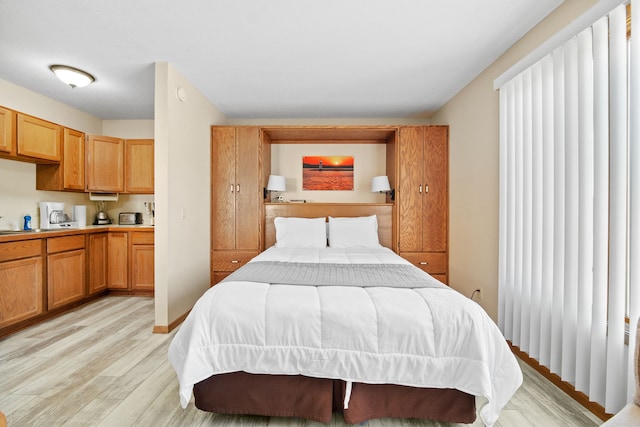 bedroom featuring light wood-style flooring