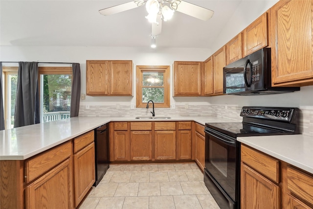 kitchen with tasteful backsplash, a sink, light countertops, black appliances, and a peninsula