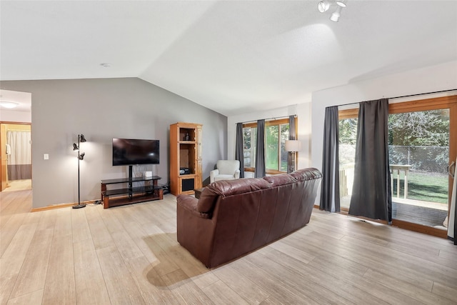 living room featuring lofted ceiling and light wood-style floors