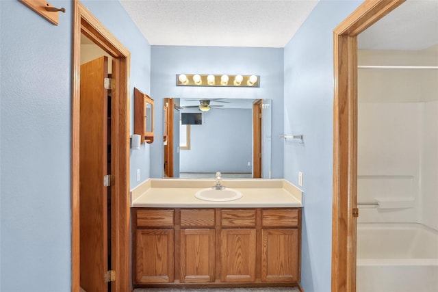 full bath featuring a ceiling fan, bathing tub / shower combination, and vanity