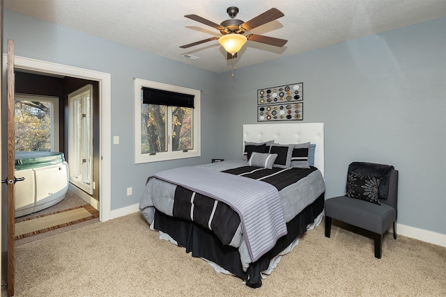 carpeted bedroom featuring a textured ceiling, visible vents, ceiling fan, and baseboards