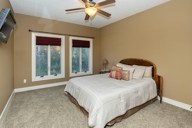carpeted bedroom with a ceiling fan and baseboards