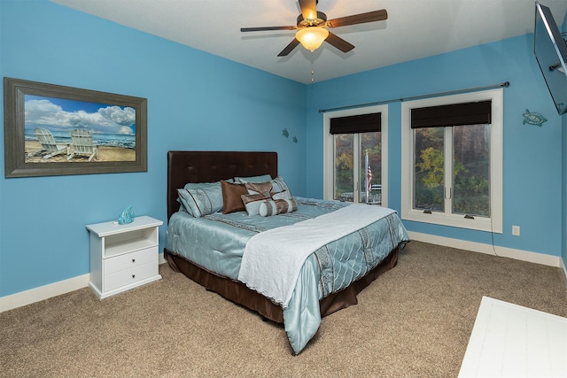 carpeted bedroom with a ceiling fan and baseboards