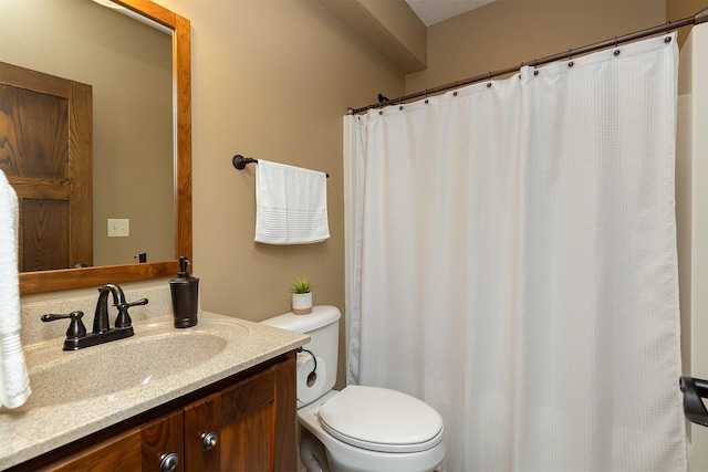 bathroom with toilet, vanity, and a shower with shower curtain