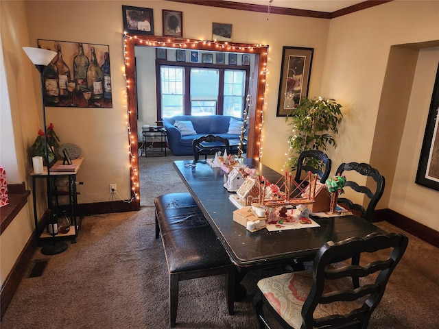 1134 39th St, Des Moines, IA 50311 - carpeted dining room featuring visible vents, crown molding, and baseboards