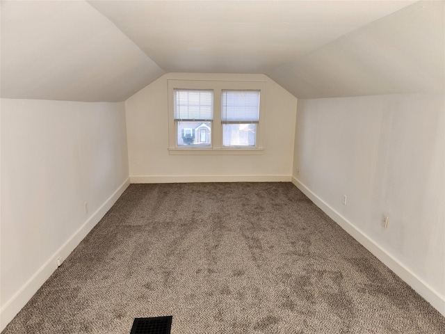 1134 39th St, Des Moines, IA 50311 - bonus room with visible vents, vaulted ceiling, dark colored carpet, and baseboards