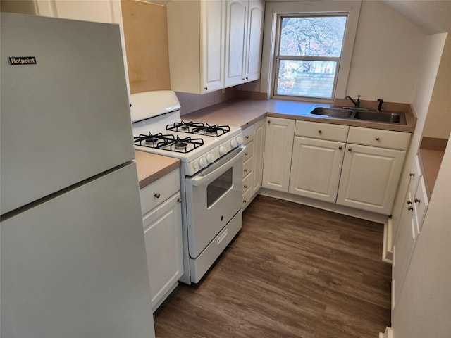 1134 39th St, Des Moines, IA 50311 - kitchen featuring white appliances, light countertops, a sink, white cabinetry, and dark wood-style floors