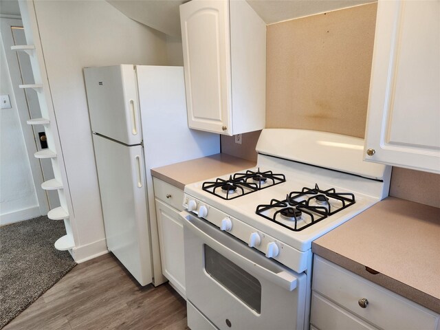 1134 39th St, Des Moines, IA 50311 - kitchen featuring white cabinetry, wood finished floors, white appliances, and light countertops
