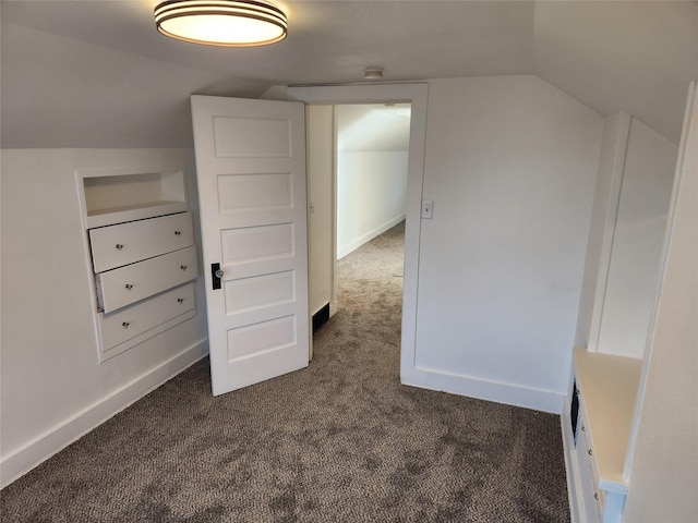 1134 39th St, Des Moines, IA 50311 - bonus room featuring lofted ceiling, baseboards, and dark carpet