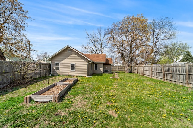 view of yard featuring a fenced backyard and a vegetable garden