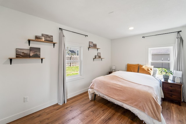 bedroom with wood finished floors, recessed lighting, and baseboards