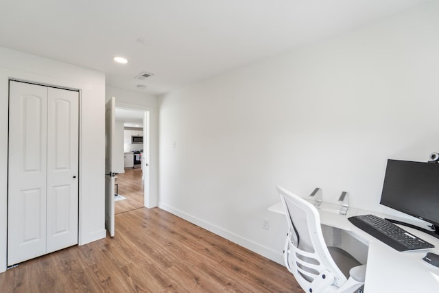 office featuring wood finished floors, recessed lighting, visible vents, and baseboards