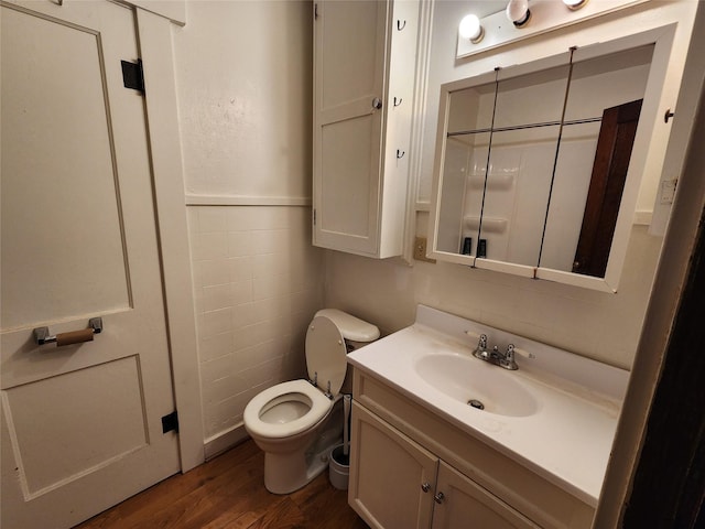 502 NE 2nd St, Greenfield, IA 50849 - bathroom with vanity, toilet, and wood finished floors