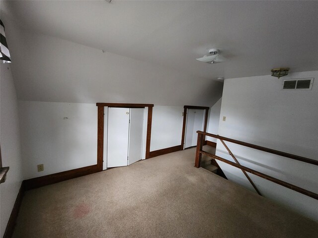 502 NE 2nd St, Greenfield, IA 50849 - additional living space featuring carpet floors, lofted ceiling, a ceiling fan, and baseboards