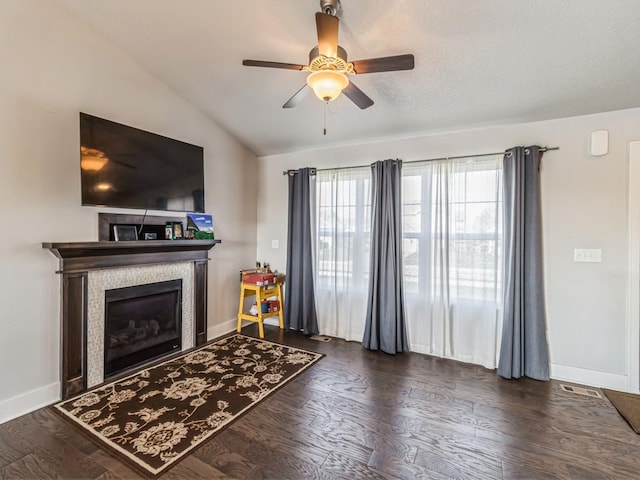 2035 SE Parkview Crossing Dr, Waukee, IA 50263 - living room with a ceiling fan, a fireplace, lofted ceiling, dark wood-style flooring, and baseboards