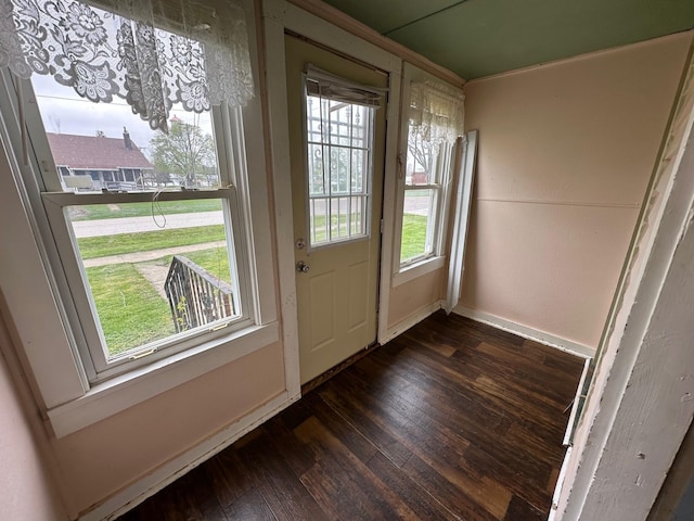 entryway with wood finished floors and baseboards