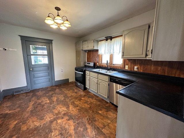 kitchen featuring dark countertops, stainless steel appliances, plenty of natural light, and a sink