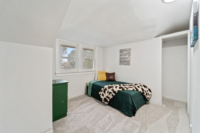 carpeted bedroom featuring baseboards