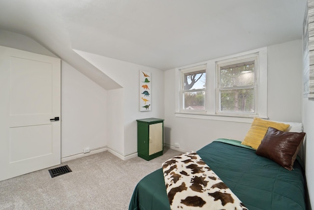 bedroom featuring light colored carpet, visible vents, vaulted ceiling, and baseboards