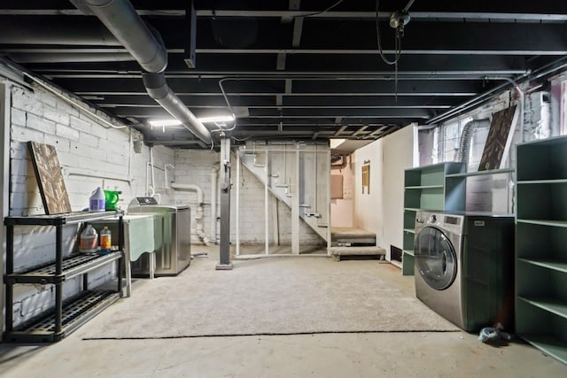 basement with stairway and washing machine and dryer