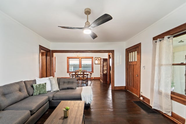 living area featuring dark wood-style floors, ceiling fan, crown molding, visible vents, and baseboards