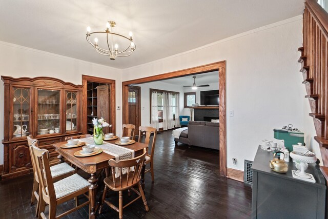 dining room featuring an inviting chandelier, dark wood-style flooring, stairway, visible vents, and ornamental molding
