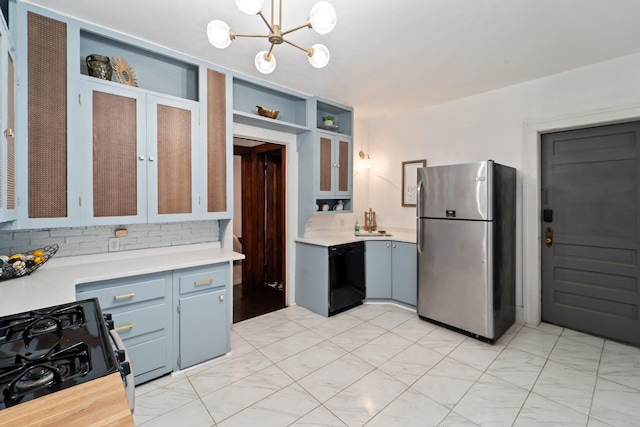kitchen featuring range with gas cooktop, dishwasher, freestanding refrigerator, and light countertops