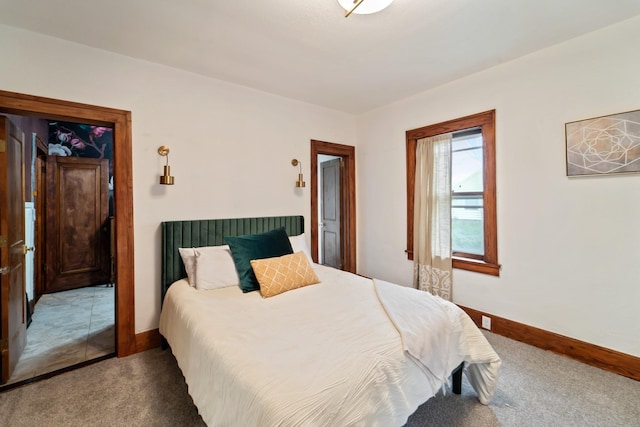 carpeted bedroom featuring baseboards