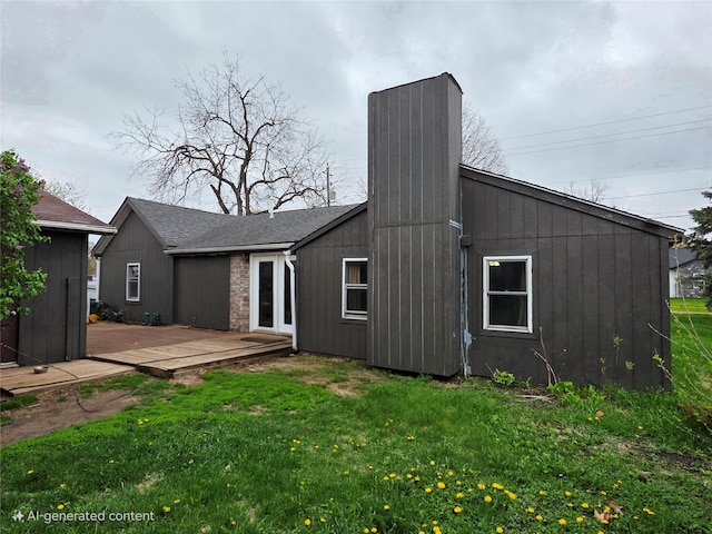 rear view of property with a lawn, a wooden deck, and a chimney