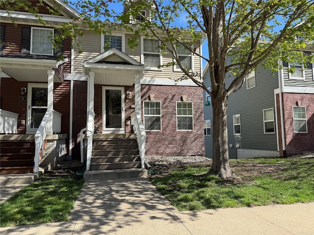 223 SE Booth Ave, Waukee, IA 50263 - view of front of home featuring covered porch and brick siding