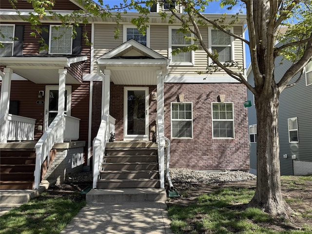 223 SE Booth Ave, Waukee, IA 50263 - view of front facade with covered porch and brick siding