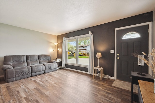 living area featuring baseboards and wood finished floors